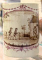 Porcelain mug painted with scene of rope making driven by spinning wheel by Lowestoft factory near Suffolk at British Museum. London, United Kingdom.