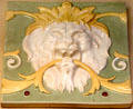 Earthenware tile with lion mask by Minton & Co of Stoke-on-Trent at British Museum. London, United Kingdom