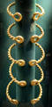 Five gold torcs with cast decorations on end by Celtic culture found Ipswich, Suffolk at British Museum. London, United Kingdom.