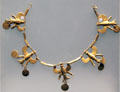 Gold necklace with flying eagles holding pendant discs from Turkey at British Museum. London, United Kingdom.