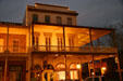 Heritage brick building with verandas at corner of 2nd & J Sts. in Old Sacramento at night. Sacramento, CA.