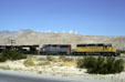 Locomotives pass wind turbines. CA.