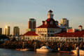 Shoreline Village shopping complex against skyline of Long Beach at sunset. Long Beach, CA.