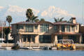 Seal Beach home against distant snow-covered mountains. Long Beach, CA.