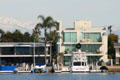 Seal Beach homes against distant snow-covered mountains. Long Beach, CA.