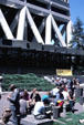 People enjoy sunshine at base of Transamerica Pyramid. San Francisco, CA.
