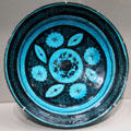 Earthenware fritware dish with flower & leaf designs from Iran at Asian Art Museum. San Francisco, CA.