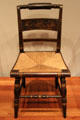 Side chair with woven rush seat by Lambert Hitchcock at de Young Museum. San Francisco, CA.