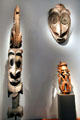 Carved house post & ceremonial house gable mask both from Sepik River plus figure from Madang all of New Guinea at de Young Museum. San Francisco, CA.