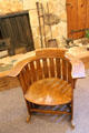 Round backed contoured wooden arm chair at Mariposa Museum. Mariposa, CA.