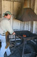 Blacksmith working at forge of Clear Creek History Park. Golden, CO.