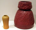 Red pottery vase with flowers & leaves by Artus Van Briggle beside unknown vase at Colorado Springs Fine Arts Center. Colorado Springs, CO.