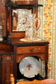 Sideboard with cut glass crystal pitcher plus China plate at Miramont Castle. Manitou Springs, CO.