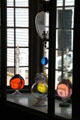Flasks with colored liquids in window of Drug Store at Mystic Seaport. Mystic, CT.