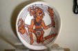 Replica of native Floridian Indian shell gorget inscribed with warrior holding severed head at Castillo de San Marcos. St Augustine, FL.