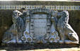 Stone coat of arms with lions in garden of The Oldest House. St Augustine, FL.