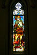 St Michael slaying dragon stained glass window in Cathedral of St John the Baptist. Savannah, GA.
