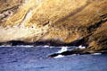 Waves crash against rocks at Hanauma Bay. Oahu, HI.