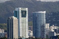 Hawaiki Tower with leaning projections to left of oval Moana Pacific Tower. Honolulu, HI.