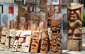 Hawaiian tikis & masks in wood carver shop at International Market Place. Waikiki, HI.