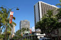 Kalakaua Ave. streetscape with Foster & Kealohilani Towers. Waikiki, HI.