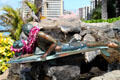 Surfer with Seal sculpture on Waikiki Beach. Waikiki, HI.
