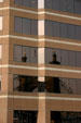 Roebling Suspension Bridge reflected in Covington highrise. Covington, KY
