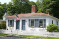 White double cottage with blue shutters Grove St. near town square. Sandwich, MA.