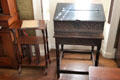Early carved document box on small table beside sheet music or similar stand at Nichols House Museum. Boston, MA.