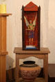Spanish-style carving of St Michael over native pot at San Miguel Mission. Santa Fe, NM.