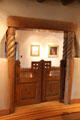 Carved swinging gates on archway at Taos Art Museum. Taos, NM.