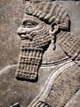 Detail of Assyrian relief of winged genie with fancy bracelets from King Ashur-nasir-pal II palace of Nimrud at Brooklyn Museum. Brooklyn, NY.
