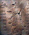 Assyrian relief of eagle-headed genie with between two sacred trees from King Ashur-nasir-pal II palace of Nimrud at Brooklyn Museum. Brooklyn, NY.
