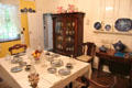 Dining table & vintage display cabinet at Home Sweet Home Museum. East Hampton, NY.