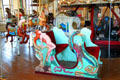 Woman on harp on carousel chariot at Merry-Go-Round Museum. Sandusky, OH.