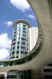 Circular pedestrian bridge over Smith Street with circular mirrored building. Houston, TX.