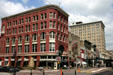 Red Italianate building through to Hotel Icon. Houston, TX.