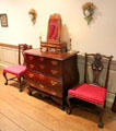 Bowed bombé chest of drawers with mirror stand & side chairs in Chippendale bedroom at Bayou Bend. Houston, TX.