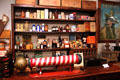 Barber pole & shelves of medicine & cosmetic bottles in General Store at Sam Houston Park. Houston, TX.