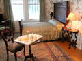 Bedroom with floral wallpaper at McFaddin-Ward House. Beaumont, TX.
