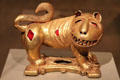 Cast gold sword ornament in form of lion by Assante culture of Ghana at Dallas Museum of Art. Dallas, TX.