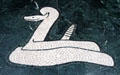 Western Diamondback Rattlesnake limestone floor mosaic detail in Great Hall of State at Fair Park. Dallas, TX.