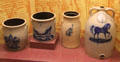 Two stoneware crocks by J&E Norton Pottery plus stoneware churn & presentation jug with horse both by E&LP Norton all of Bennington, VT at Bennington Museum. Bennington, VT.