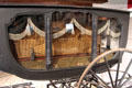 Window details of with symbolic inextinguishable eternal flames on hearse by A. Tolman & Co. of Worcester, MA in Round Barn at Shelburne Museum. Shelburne, VT.