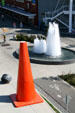 Fountain with statues at Elliott Ave. end of Olympic Sculpture Park with giant art Safety Cone by Dennis Oppenheim. Seattle, WA.