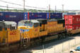 Union Pacific diesel locomotive passing container train. Cheyenne, WY.