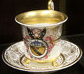 Soft--paste porcelain cabinet cup & saucer with Latin "God & Country" emblem, made in Nantgarw, Wales & possibly decorated by Chamberlain of Worcester at National Museum of Wales. Cardiff, Wales.