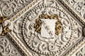 Diamond shaped panel of ornate ceiling containing gilded elements, fleurs-de-lis, & sculpted plaster figures of beasts in Library at Penrhyn Castle. Bangor, Wales.
