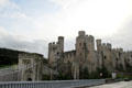 Conwy Castle with modern road bridge & Thomas Telford's famous suspension bridge in the foreground. Conwy, Wales.