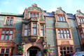 Castle Hotel on High St. with facade composed of small broken pieces of limestone. Conwy, Wales.